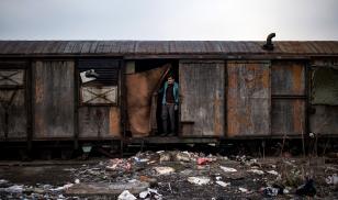 A migrant stands inside an abandoned train wagon used as a makeshift shelter near the main rail station in Belgrade, Serbia. Andrej Isakovic, AFP/Getty Images